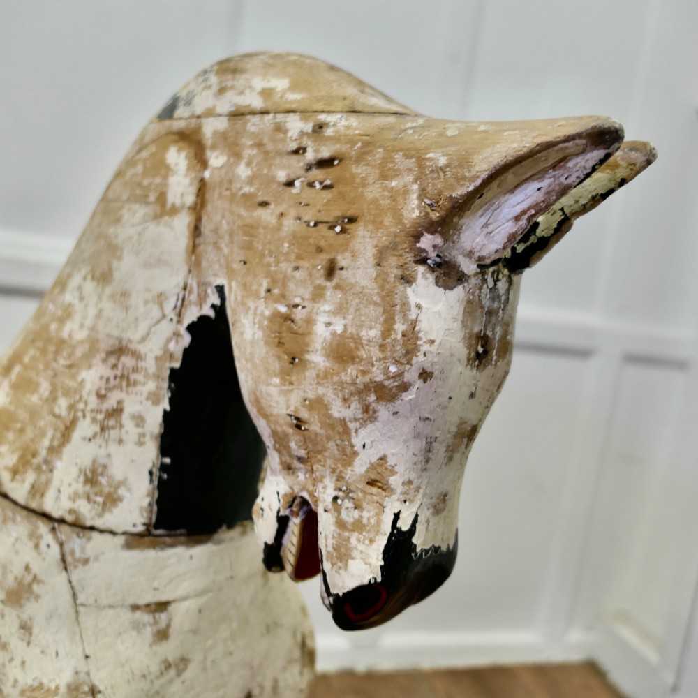A large carved pine rocking horse figure with a heavily distressed off-white and black painted finish, detached from its original rocker base. View V