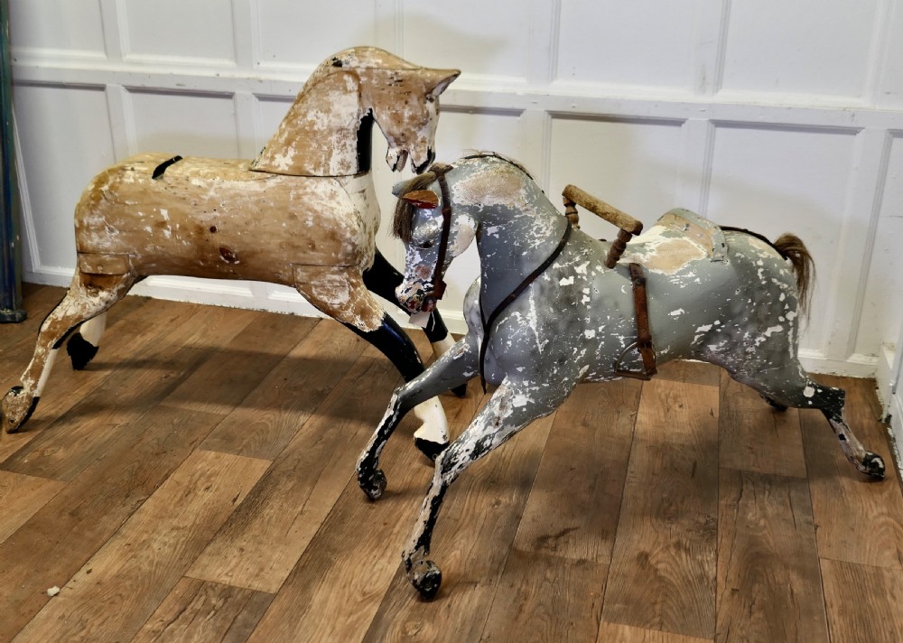 A large carved pine rocking horse figure with a heavily distressed off-white and black painted finish, detached from its original rocker base. View VII