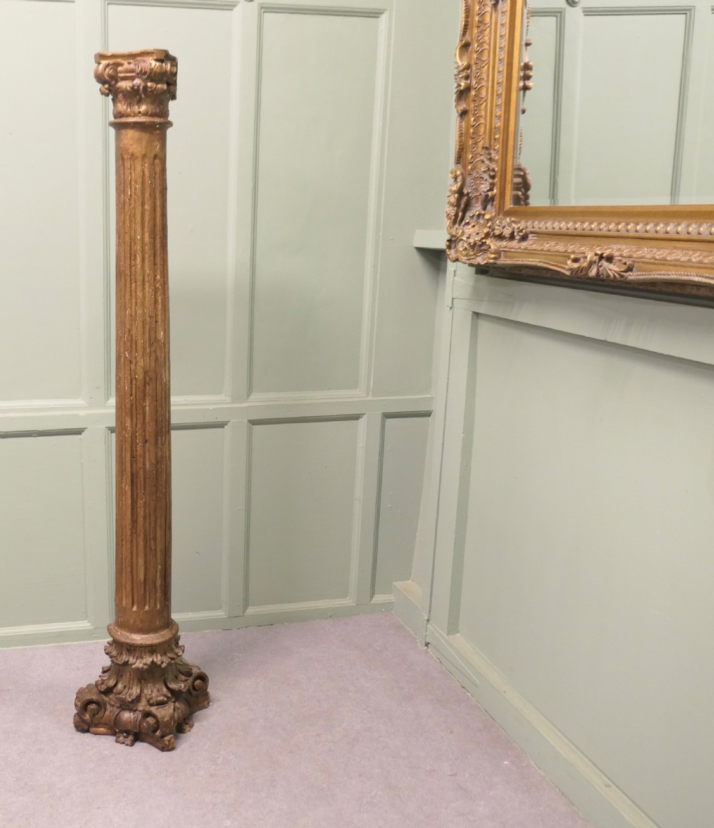 A tall, carved giltwood Corinthian column pedestal featuring a fluted shaft, acanthus leaf capital, and decorative base. View II
