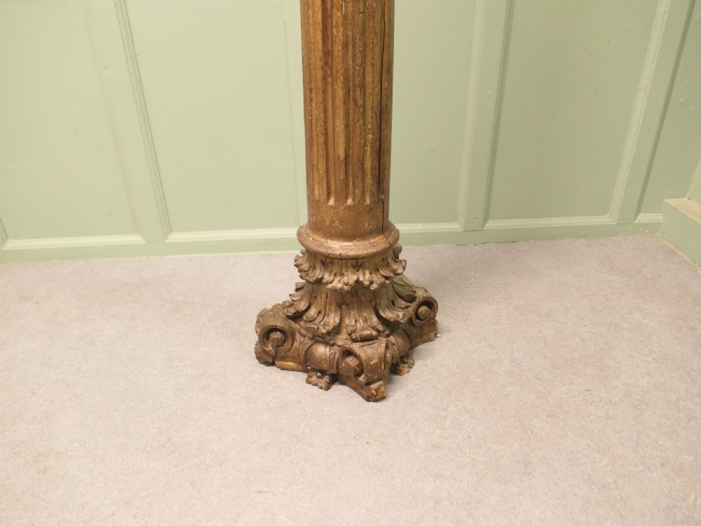 A tall, carved giltwood Corinthian column pedestal featuring a fluted shaft, acanthus leaf capital, and decorative base. View IV