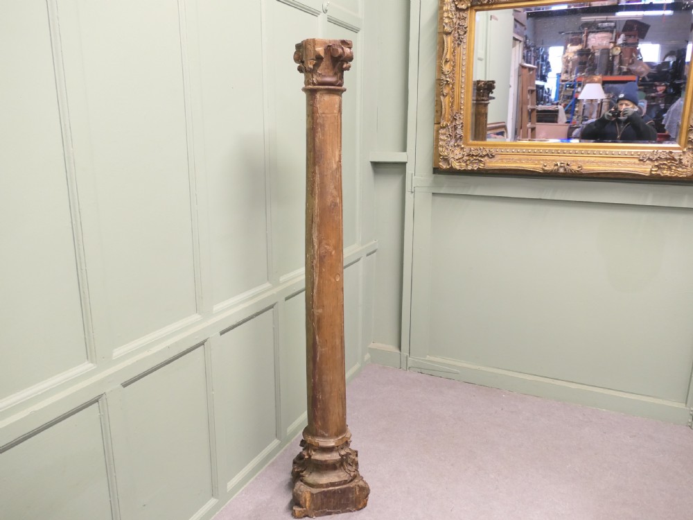 A tall, carved giltwood Corinthian column pedestal featuring a fluted shaft, acanthus leaf capital, and decorative base. View VI