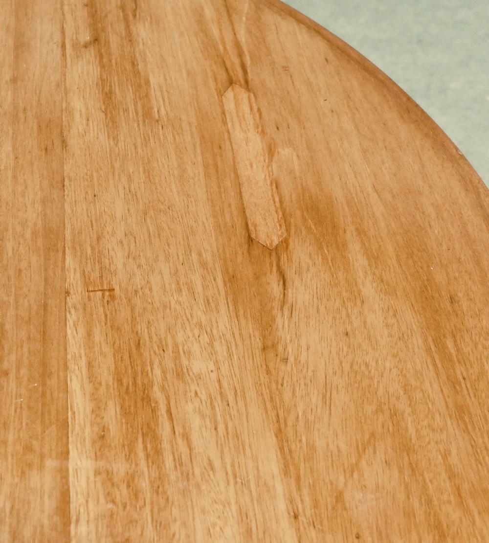 A circular cherrywood centre table featuring a polished tilt-top surface, a central stem, and a carved petal-form pedestal base on ball feet. View III