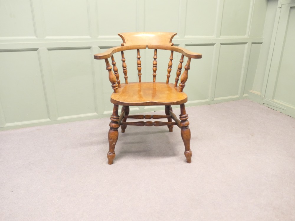 A 19th-century wooden smokers bow desk chair crafted from beech and elm with turned spindles and a shaped saddle seat. View III