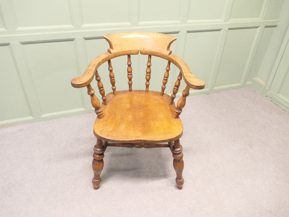 A 19th-century wooden smokers bow desk chair crafted from beech and elm with turned spindles and a shaped saddle seat. View IV