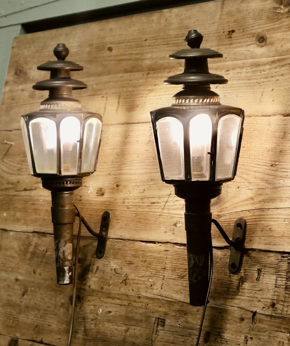 A pair of wall-mounted French brass carriage lanterns featuring tiered chimney tops and glazed glass panels. View II