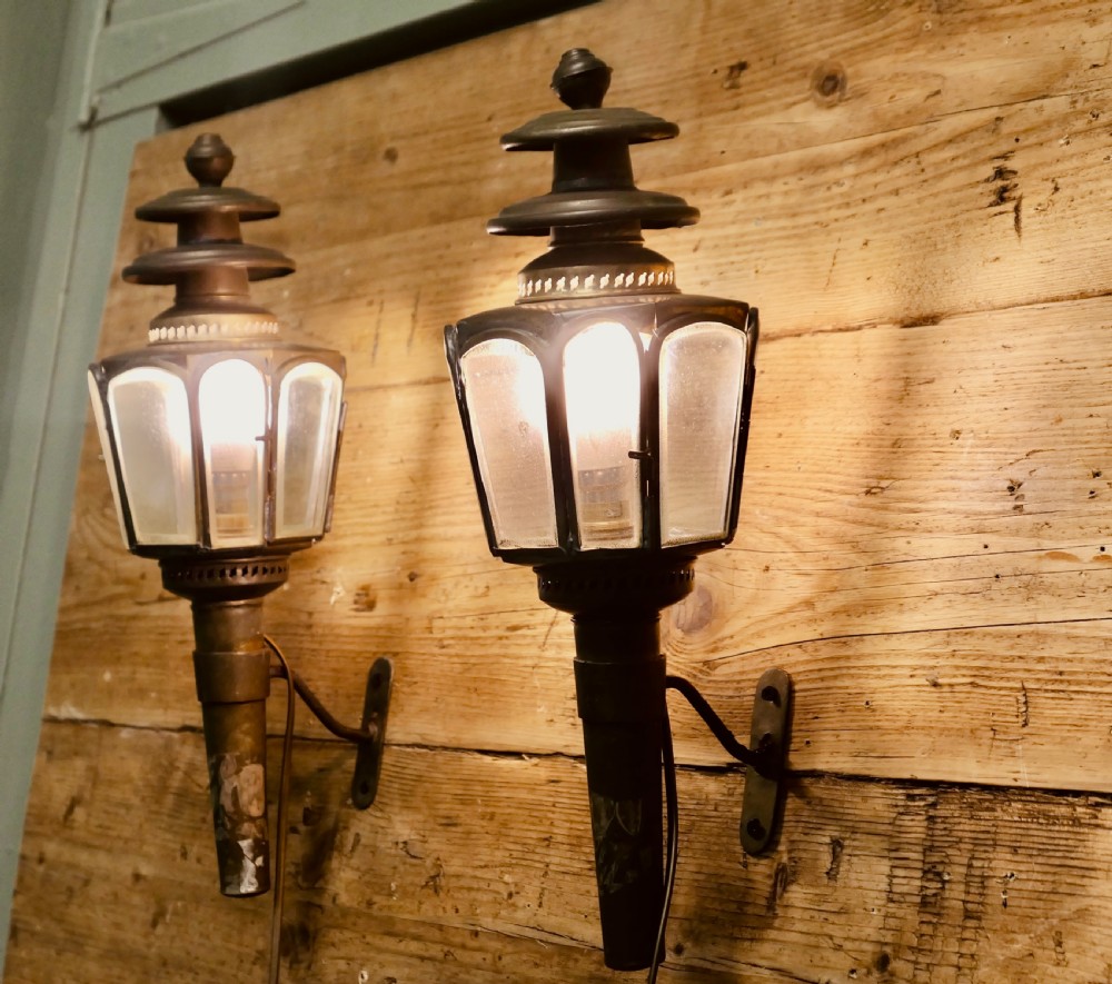 A pair of wall-mounted French brass carriage lanterns featuring tiered chimney tops and glazed glass panels. View III