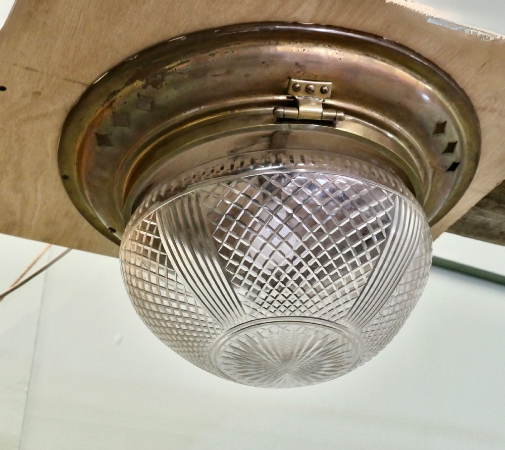 An Art Deco flush mount ceiling light featuring a hemispherical cut glass shade with geometric diamond patterns set into a dark metal collar with diamond-shaped perforations. View III