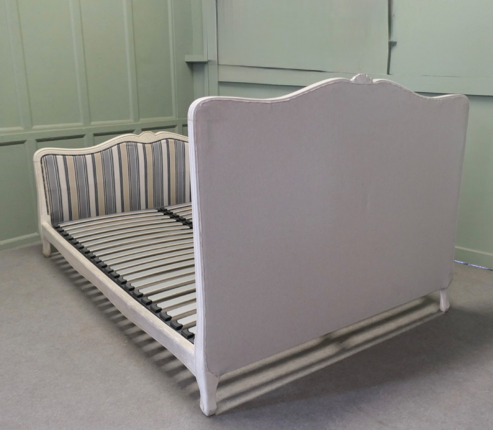 A French Louis XV style double bed featuring a cream painted carved wooden frame and grey striped upholstered headboard and footboard. View V