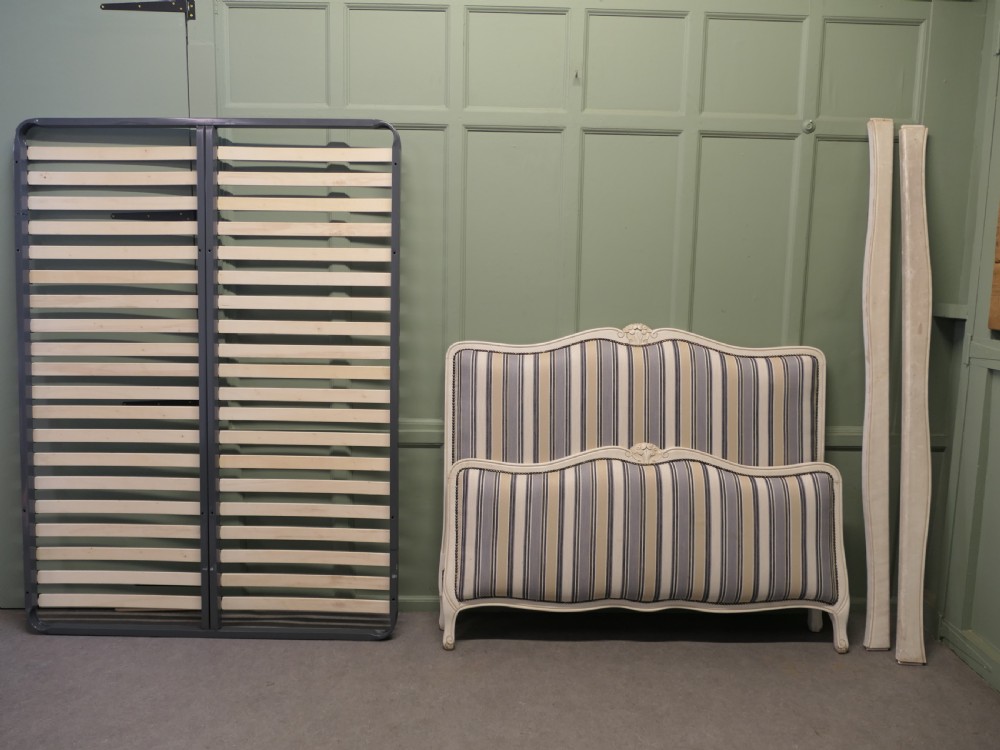 A French Louis XV style double bed featuring a cream painted carved wooden frame and grey striped upholstered headboard and footboard. View VI