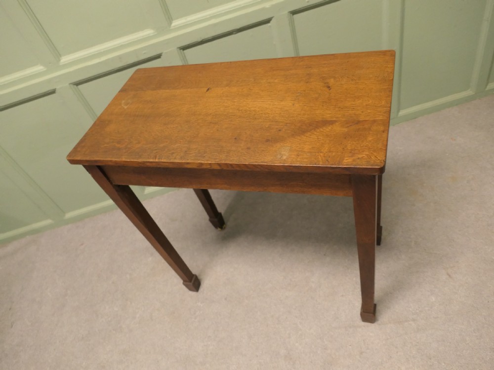 A rectangular Arts and Crafts solid oak side table featuring straight tapered legs ending in block feet. View III