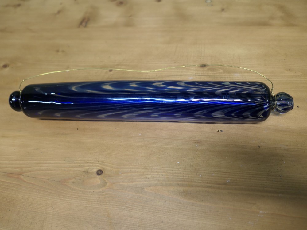 A pair of 19th-century hand-blown glass rolling pins featuring swirled trailing patterns in cobalt blue and ruby red. View II