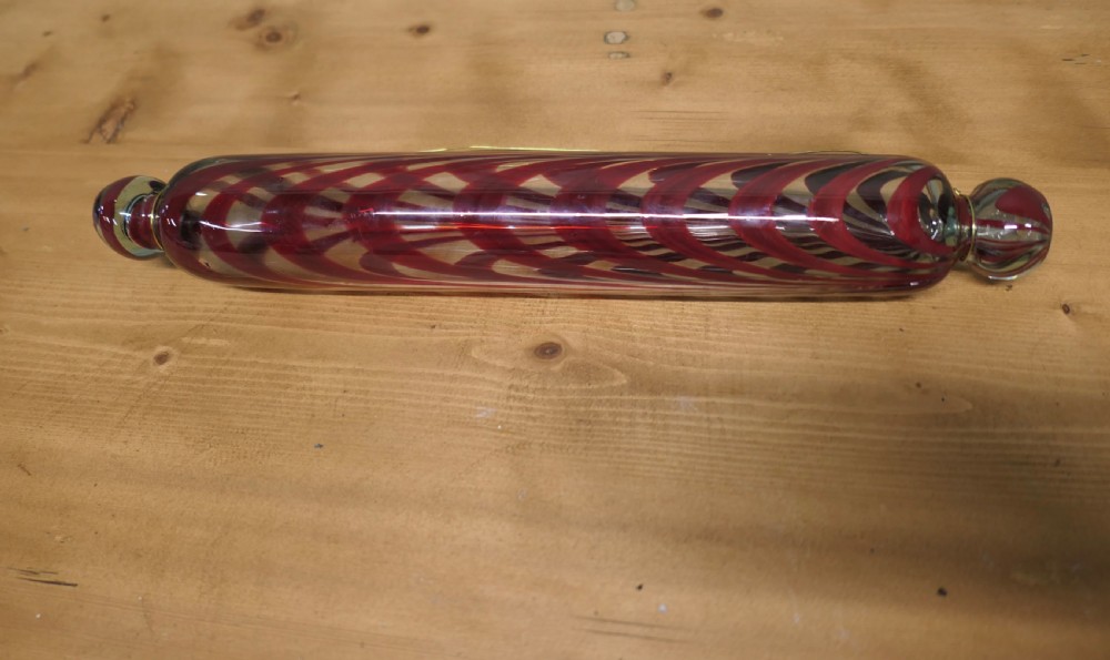 A pair of 19th-century hand-blown glass rolling pins featuring swirled trailing patterns in cobalt blue and ruby red. View III