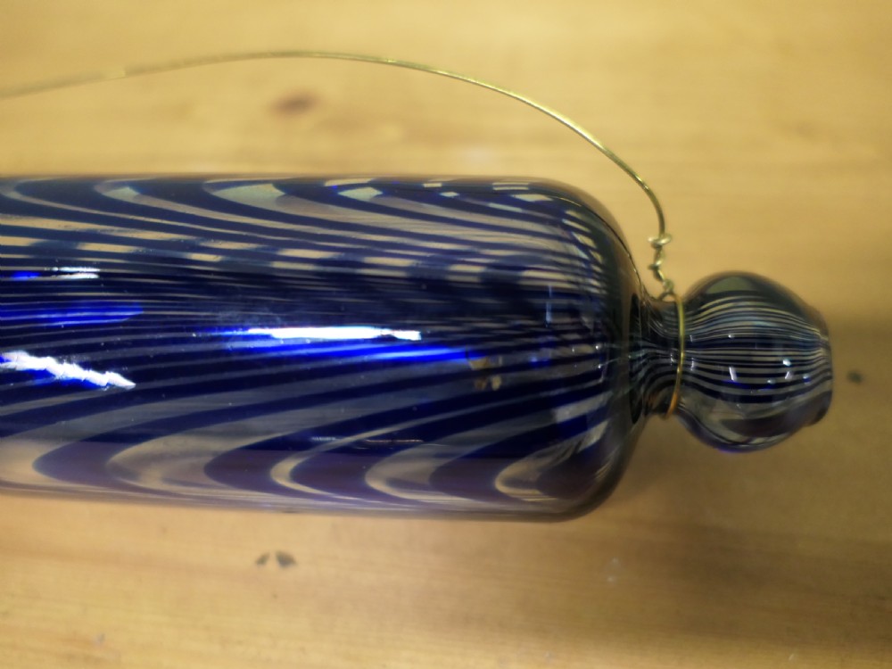 A pair of 19th-century hand-blown glass rolling pins featuring swirled trailing patterns in cobalt blue and ruby red. View V