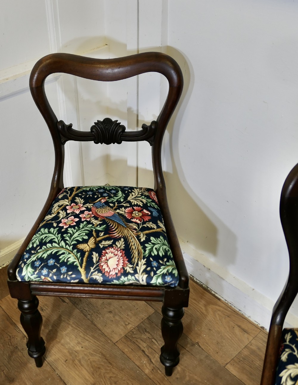 A set of six Victorian mahogany balloon-back dining chairs with carved mid-rails and blue floral patterned velvet seats. View II