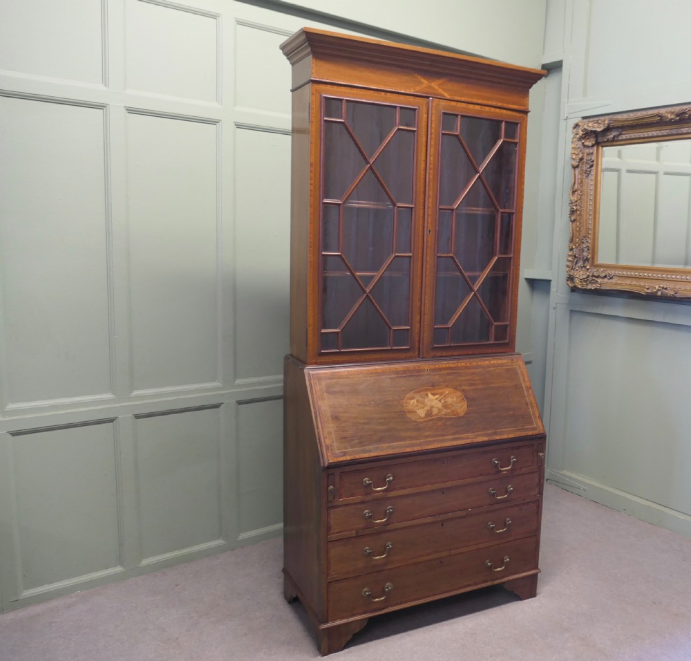 An Edwardian mahogany bureau bookcase featuring an upper cabinet with astragal glazed doors, a sloping fall-front writing surface with marquetry inlay, and four lower drawers with brass handles. View II