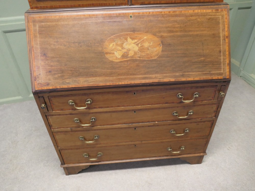 An Edwardian mahogany bureau bookcase featuring an upper cabinet with astragal glazed doors, a sloping fall-front writing surface with marquetry inlay, and four lower drawers with brass handles. View III