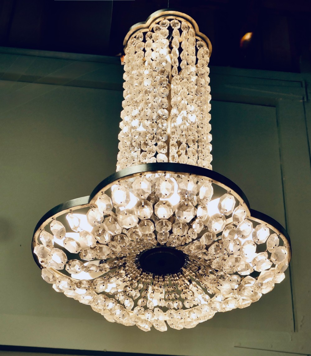 A large Art Deco tiered ceiling chandelier featuring cylindrical and cascading tiers of faceted clear crystal beads supported by a polished metal frame. View II