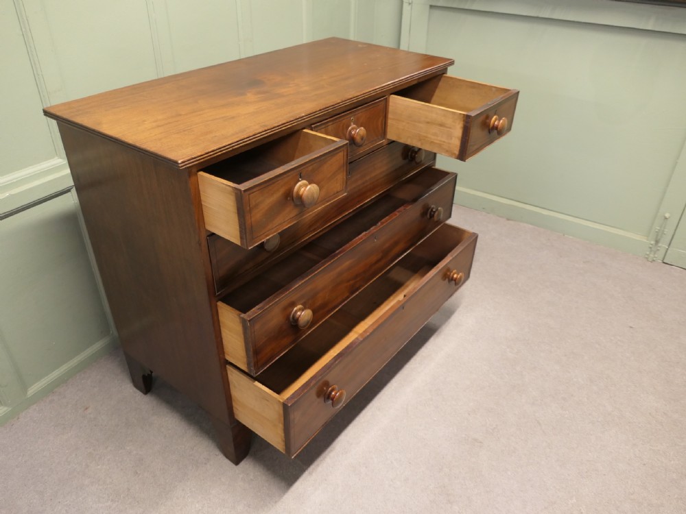 A late 18th-century Georgian mahogany chest of drawers featuring three small top drawers above three full-width drawers with turned wooden handles and a curved lower apron. View III