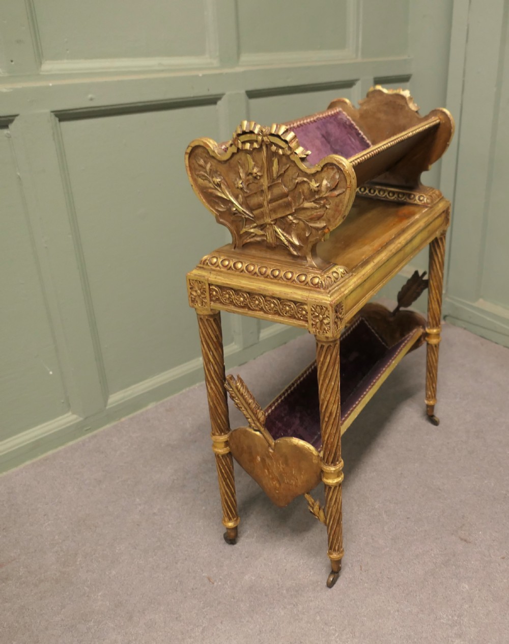 A gilded wooden two-tier book trough featuring spiral legs, carved cresting, and purple velvet lining. View IV