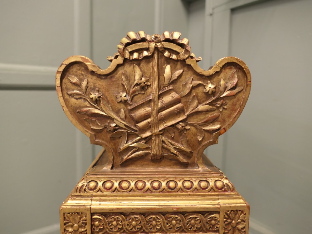 A gilded wooden two-tier book trough featuring spiral legs, carved cresting, and purple velvet lining. View VI