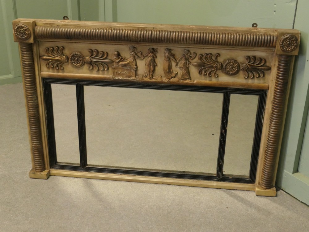 A horizontal Regency style triple plate overmantel mirror with a classical relief frieze, reeded side columns, and corner rosettes. View IV