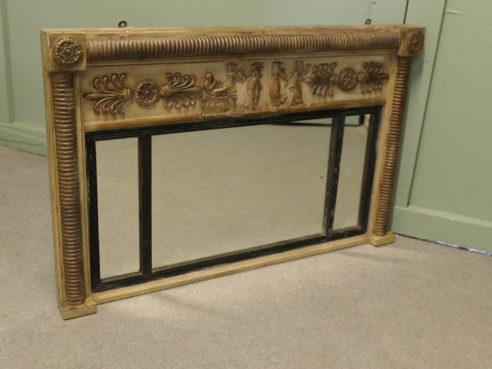A horizontal Regency style triple plate overmantel mirror with a classical relief frieze, reeded side columns, and corner rosettes. View V