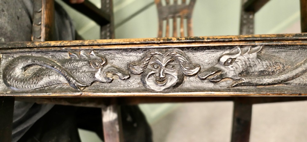 A dark hand-carved Chippendale style armchair featuring a pierced back splat, carved armrests, geometric leg carving, and a relief-carved lower seat apron. View II