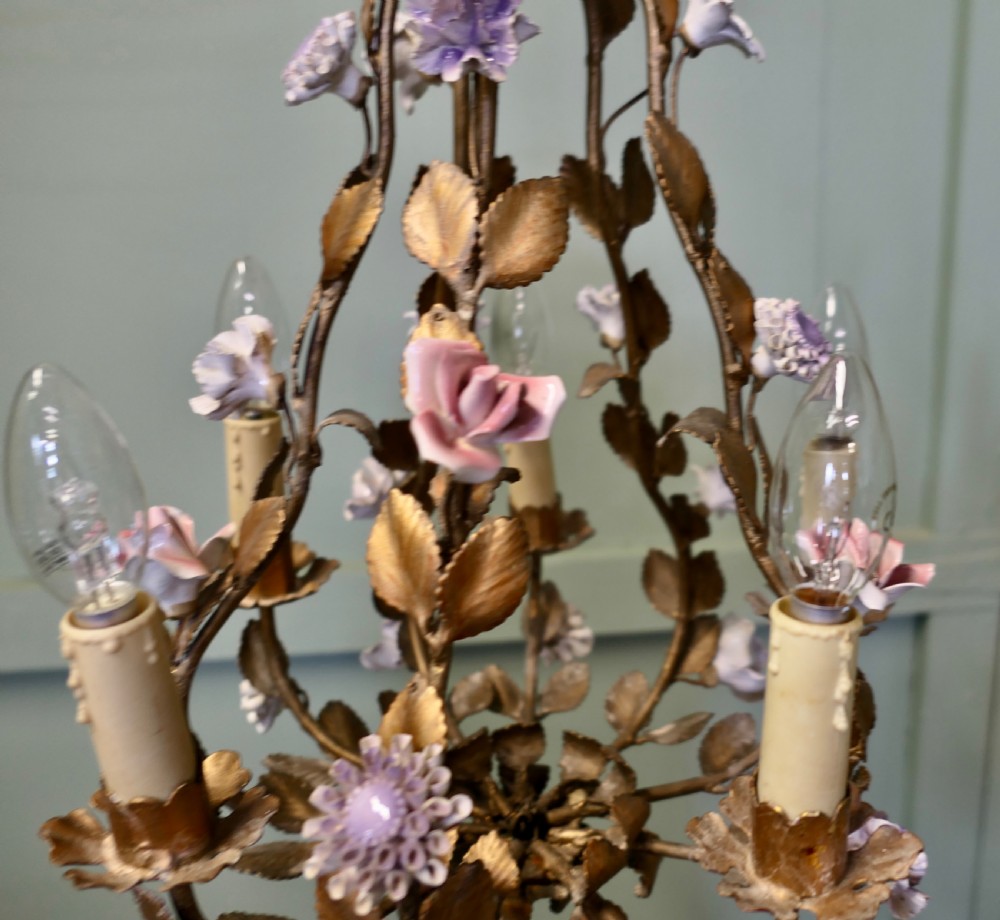 A French gilt toleware six-branch chandelier featuring metal leaf foliage and purple ceramic flowers. View III