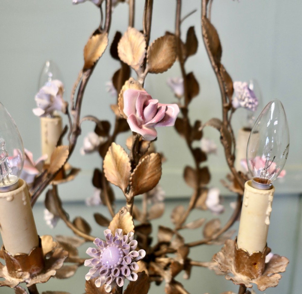 A French gilt toleware six-branch chandelier featuring metal leaf foliage and purple ceramic flowers. View V