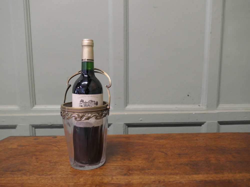 A small French Art Nouveau clear glass personal ice bucket featuring spiral fluted sides and an ornate brass collar with a swing handle. View V