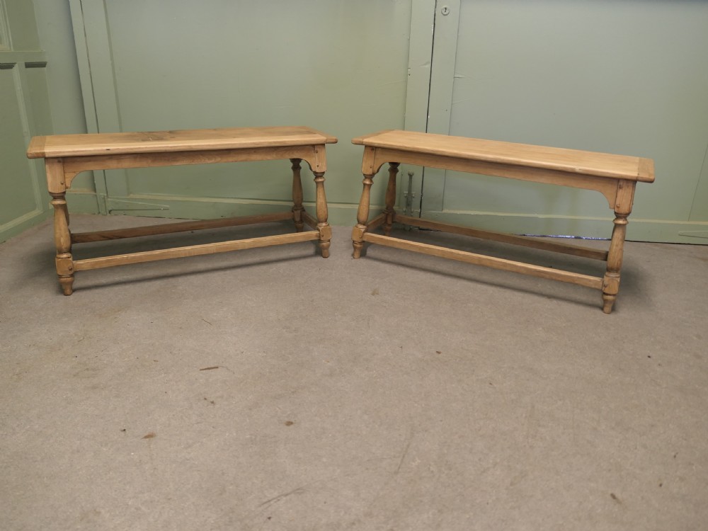 A pair of matching long bleached oak joint benches featuring turned legs, box stretchers, and arched aprons. View II