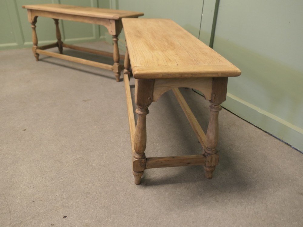A pair of matching long bleached oak joint benches featuring turned legs, box stretchers, and arched aprons. View III