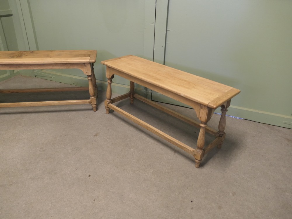 A pair of matching long bleached oak joint benches featuring turned legs, box stretchers, and arched aprons. View VI