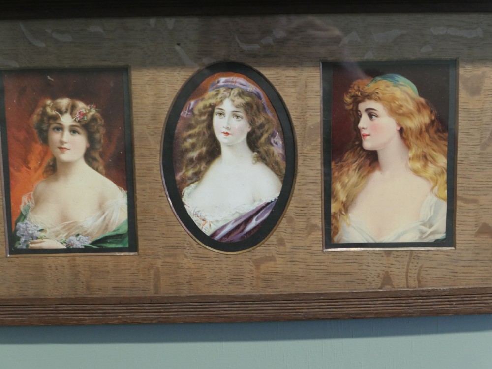 A horizontal dark oak wall shelf featuring six mounted Pre-Raphaelite style female portraits set behind alternating rectangular and oval apertures. View III
