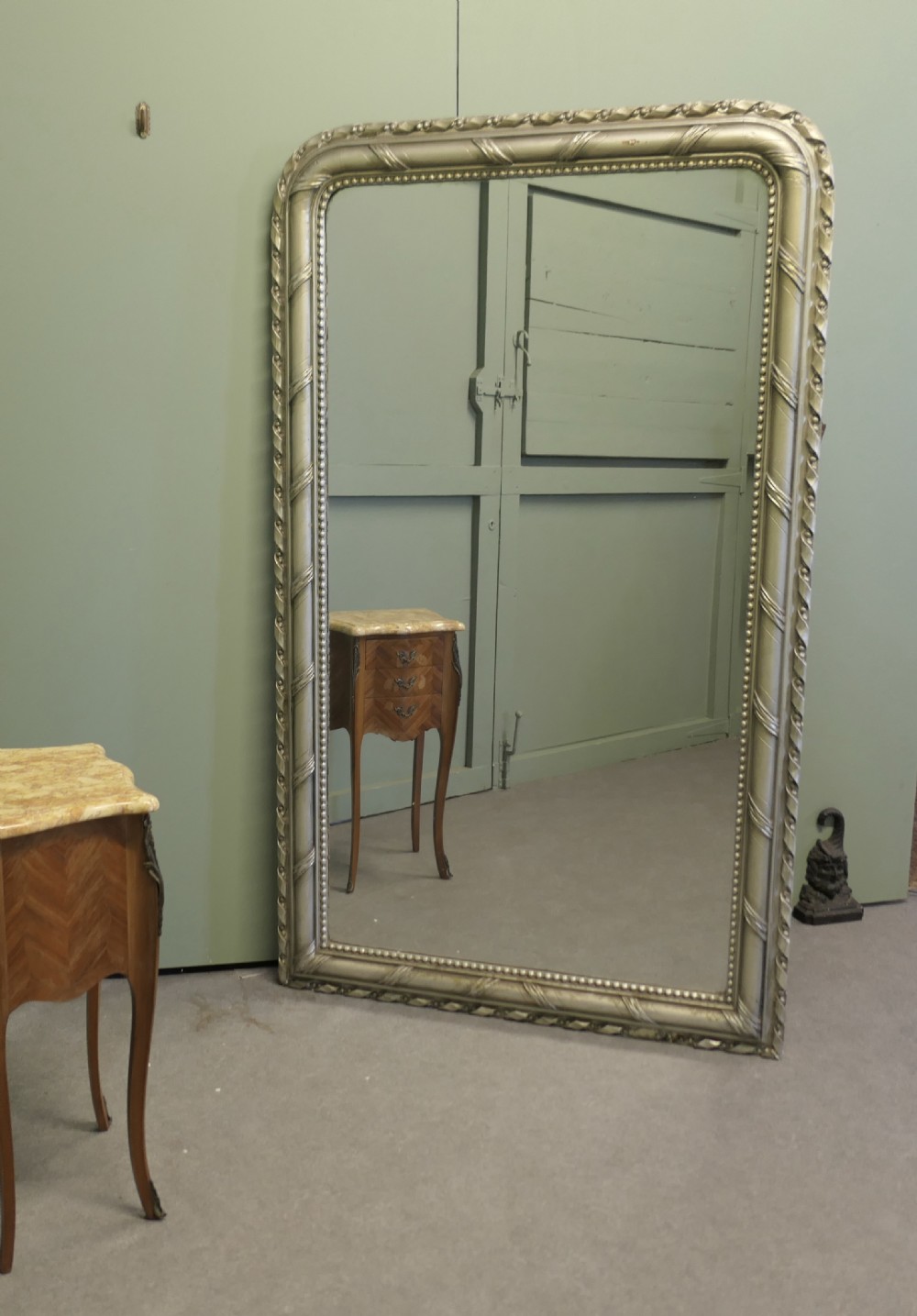 A tall French Louis Philippe mirror featuring a silver gilt frame with rounded upper corners, beaded inner trim, and rope moulding. View II