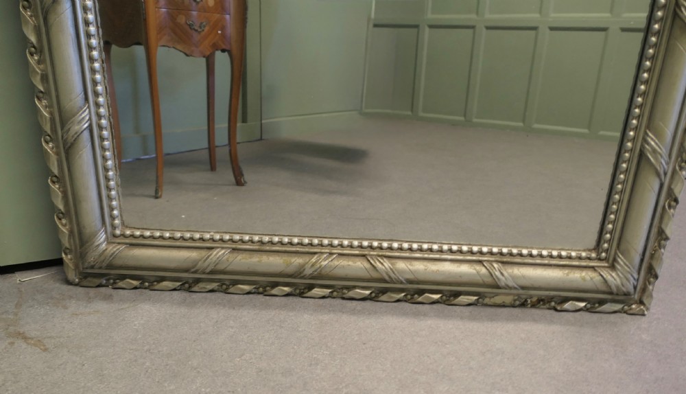 A tall French Louis Philippe mirror featuring a silver gilt frame with rounded upper corners, beaded inner trim, and rope moulding. View III