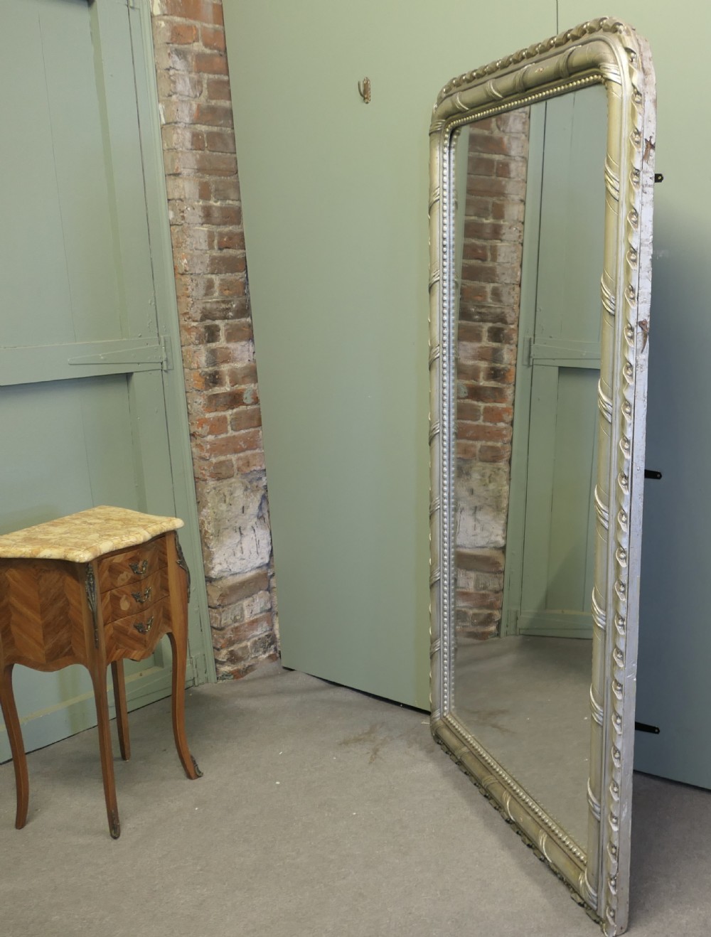A tall French Louis Philippe mirror featuring a silver gilt frame with rounded upper corners, beaded inner trim, and rope moulding. View IV
