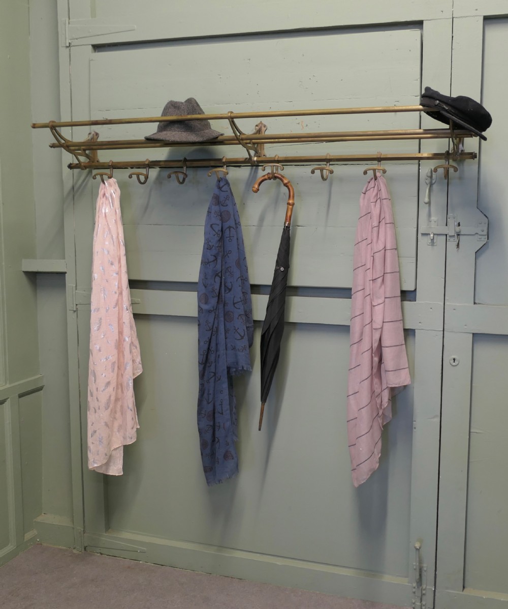 A 5ft French Art Deco brass wall-mounted hat and coat rack featuring an upper slatted shelf rail and eight sliding double hooks. View VII