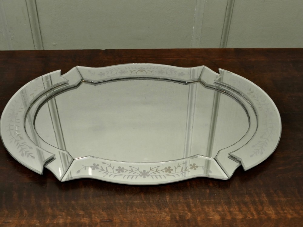 An Art Deco shaped mirrored glass tray featuring etched floral motifs and bevelled cut-glass borders. View V