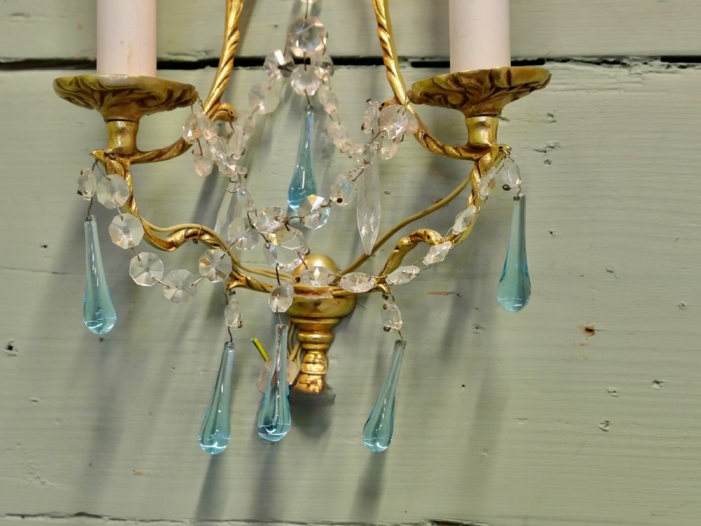 A pair of French gilt brass two-arm wall sconces decorated with clear and blue crystal glass droplets. View III