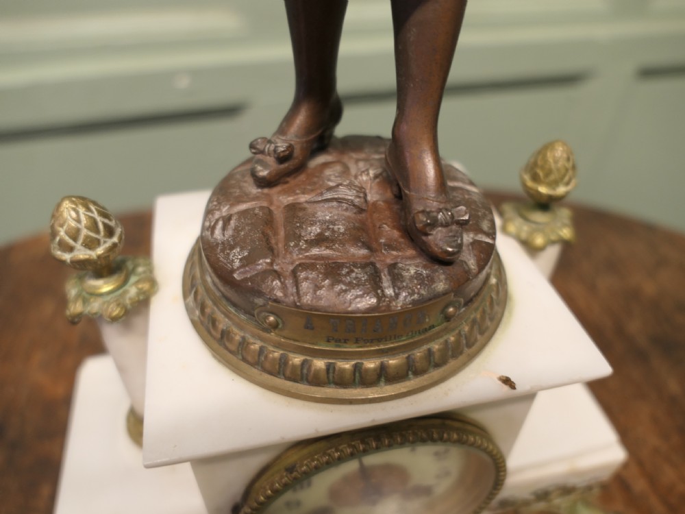 A nineteenth-century French clock garniture set comprising a central bronze sculpture on a marble clock base flanked by two matching multi-arm bronze candelabras. View III