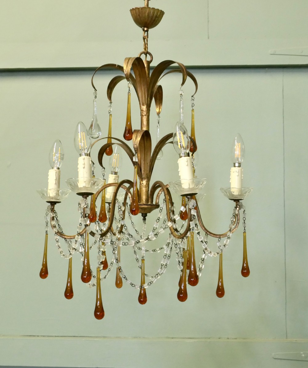 A French gilt metal toleware chandelier featuring curved foliage branches, candle-style bulb holders, clear beaded swags, and suspended amber glass teardrops. View III
