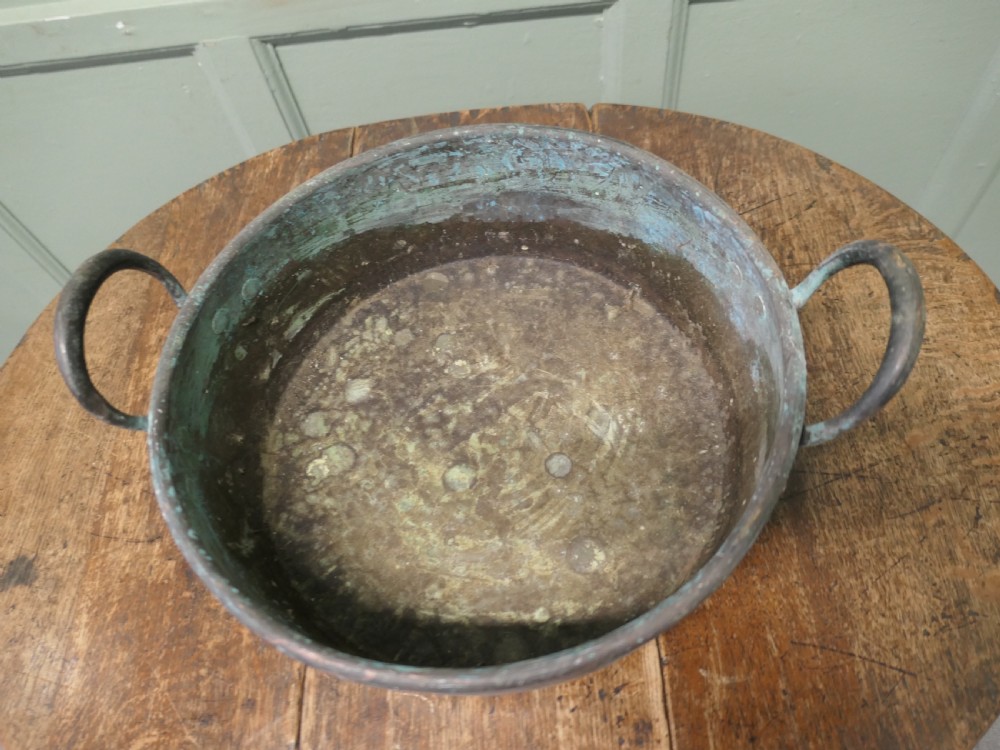A large 19th-century copper preserving pan featuring twin riveted handles and a patinated finish with hints of verdigris. View IV