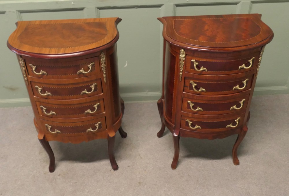 A near pair of French Louis XV style bow-front wooden bedside cabinets with four drawers, brass handles, and cabriole legs. View II