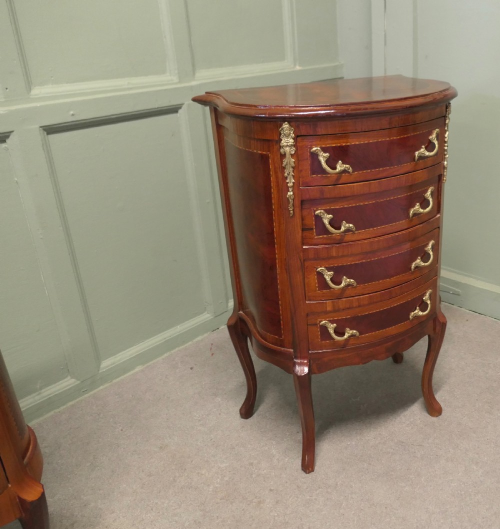 A near pair of French Louis XV style bow-front wooden bedside cabinets with four drawers, brass handles, and cabriole legs. View IV
