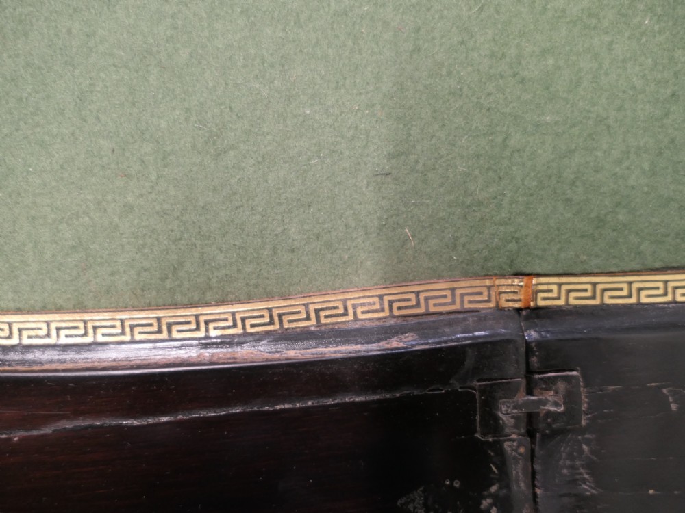A French Louis XV style ebonised games table featuring brass inlay, decorative ormolu mounts, and slender cabriole legs. View VI