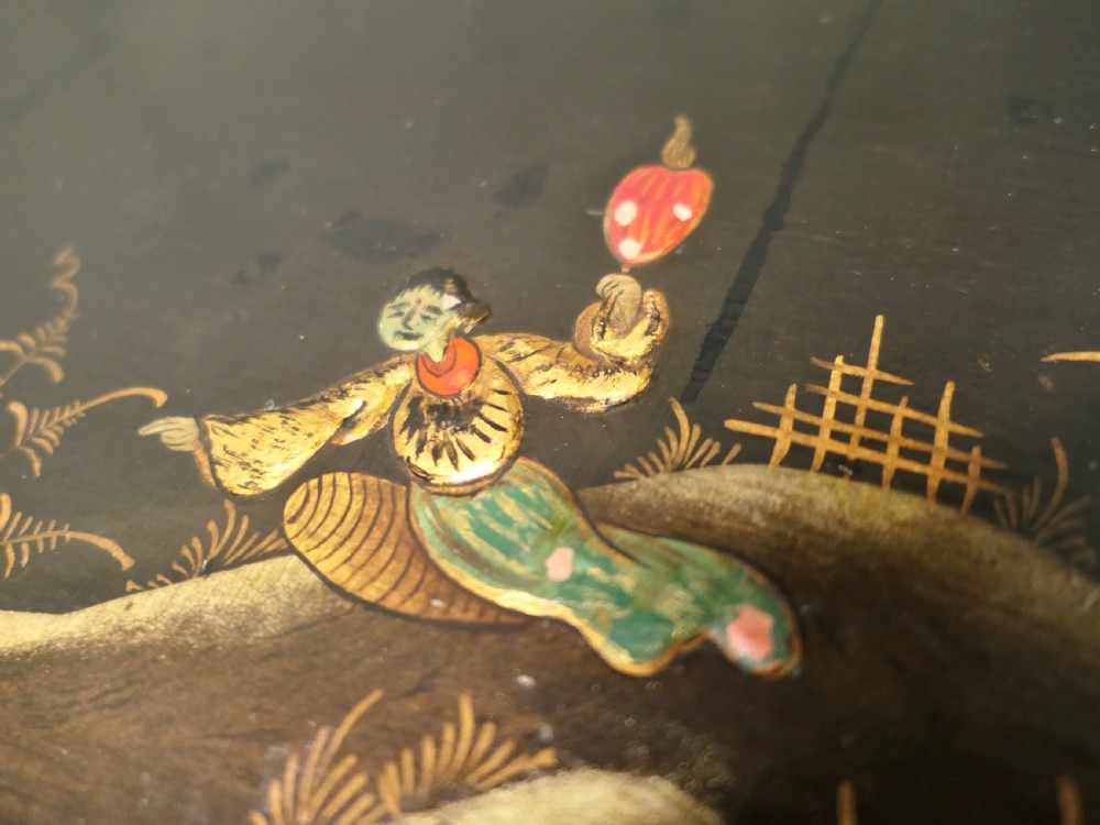 A black lacquered cupboard featuring hand-painted Chinoiserie landscape scenes, two upper doors, two lower drawers, and metal handles. View II