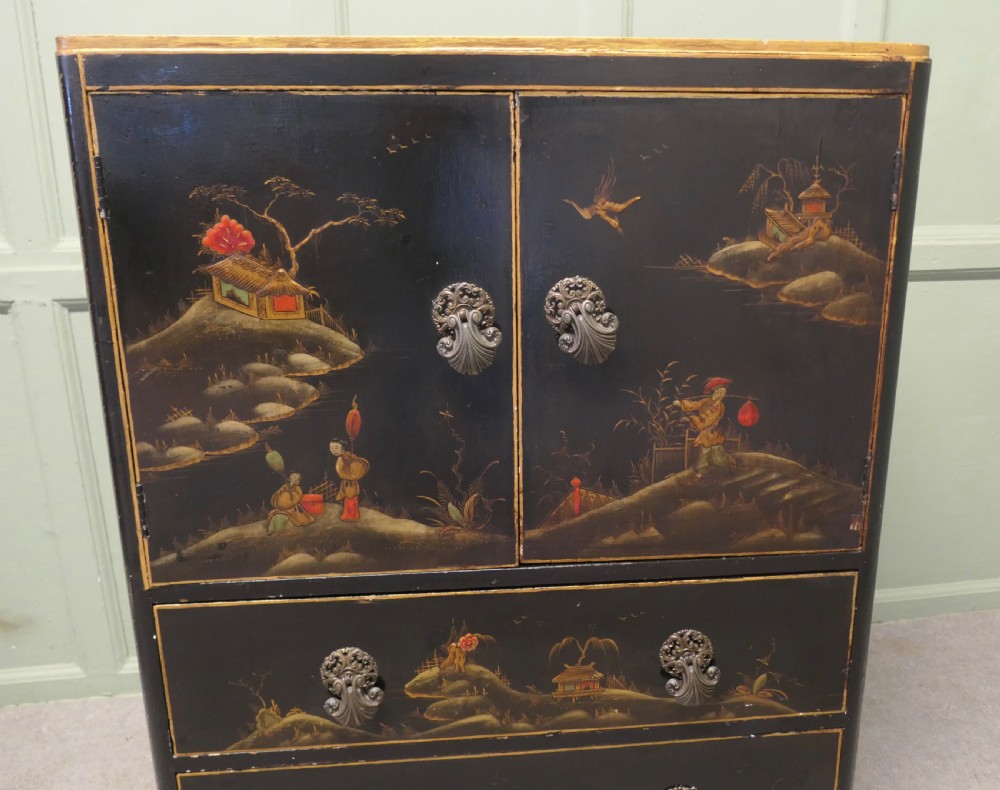 A black lacquered cupboard featuring hand-painted Chinoiserie landscape scenes, two upper doors, two lower drawers, and metal handles. View III