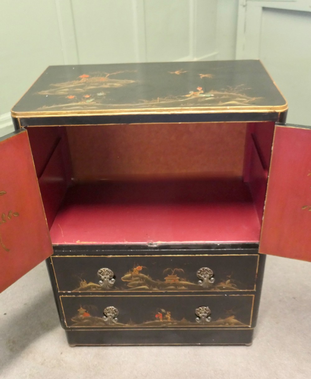 A black lacquered cupboard featuring hand-painted Chinoiserie landscape scenes, two upper doors, two lower drawers, and metal handles. View IV