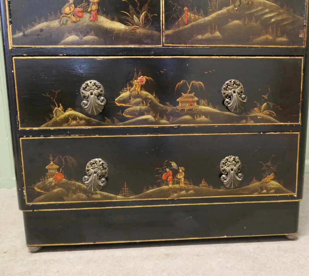 A black lacquered cupboard featuring hand-painted Chinoiserie landscape scenes, two upper doors, two lower drawers, and metal handles. View VII